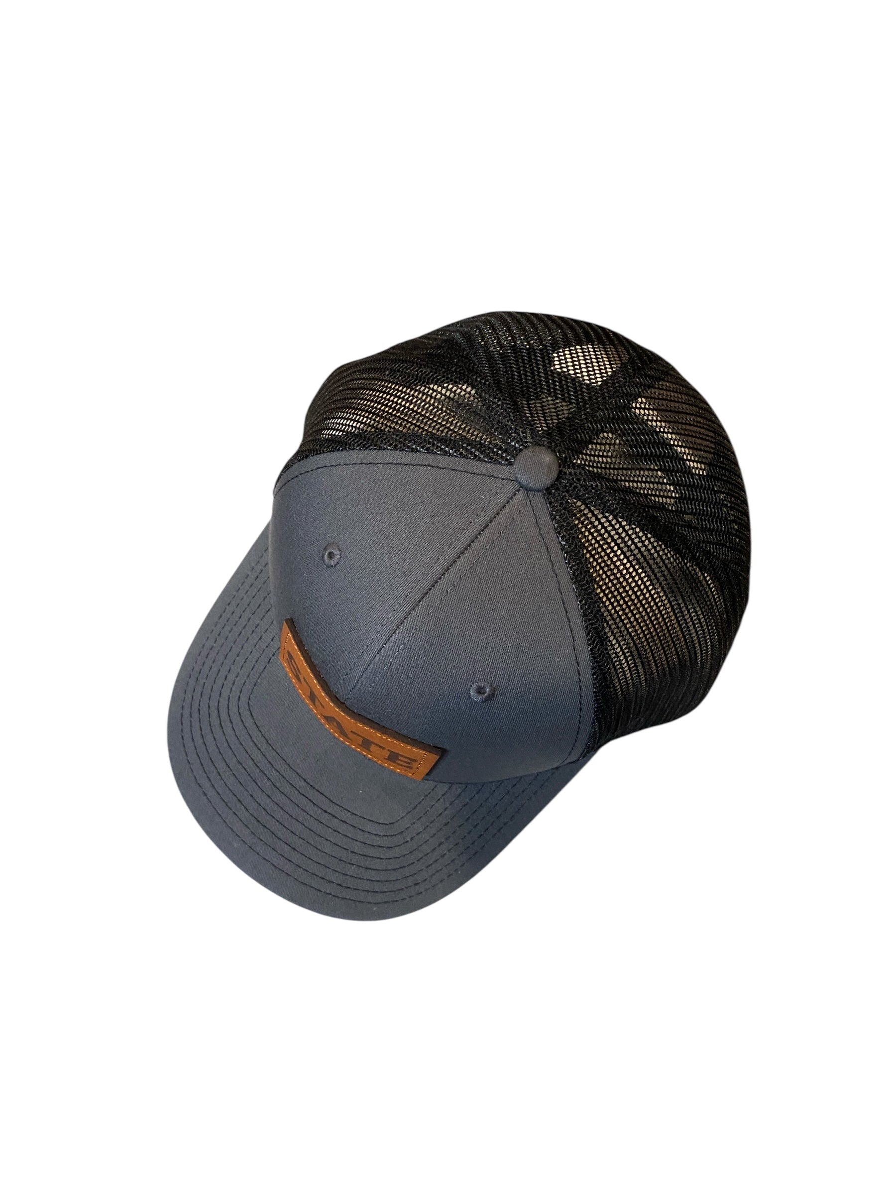 Leather patch STATE Trucker Hat in charcoal/black mesh