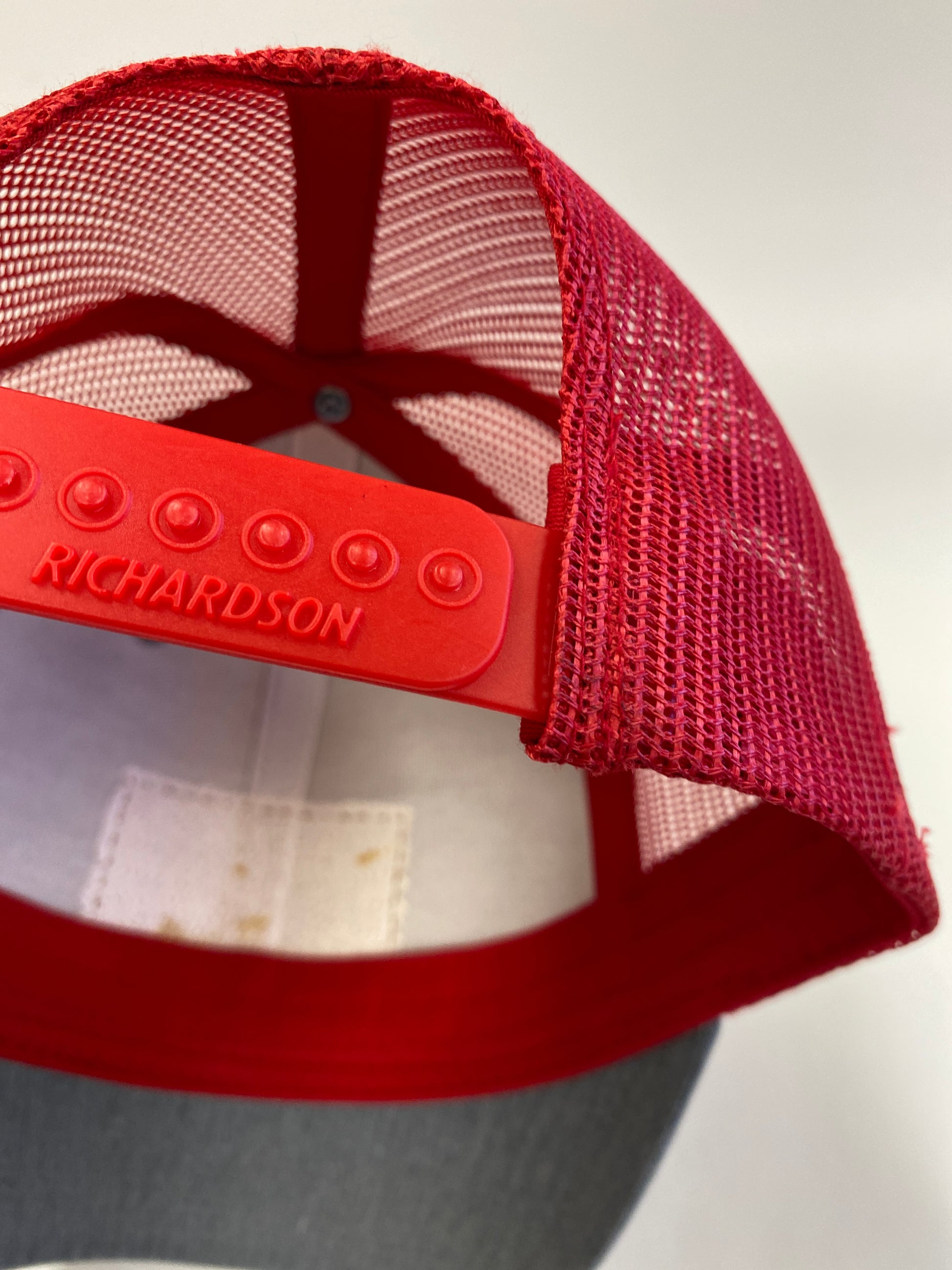 Leather Patch NORTH Trucker Hat in heather gray/red mesh