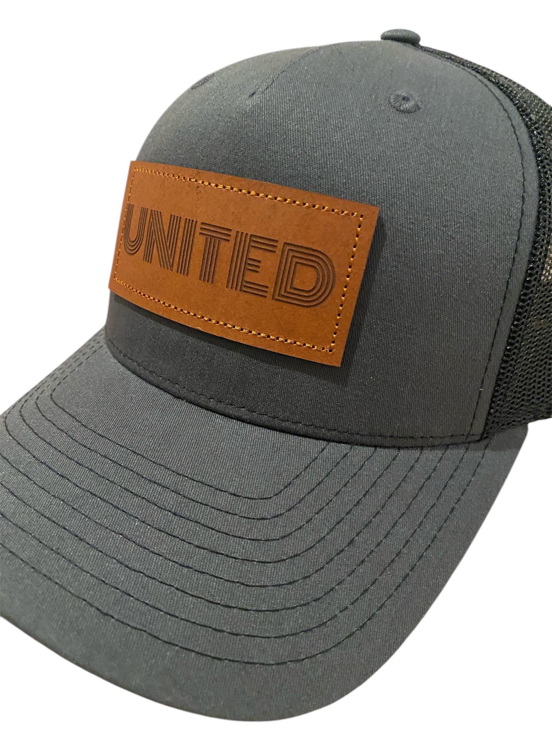 Leather Patch UNITED Trucker Hat in charcoal/black