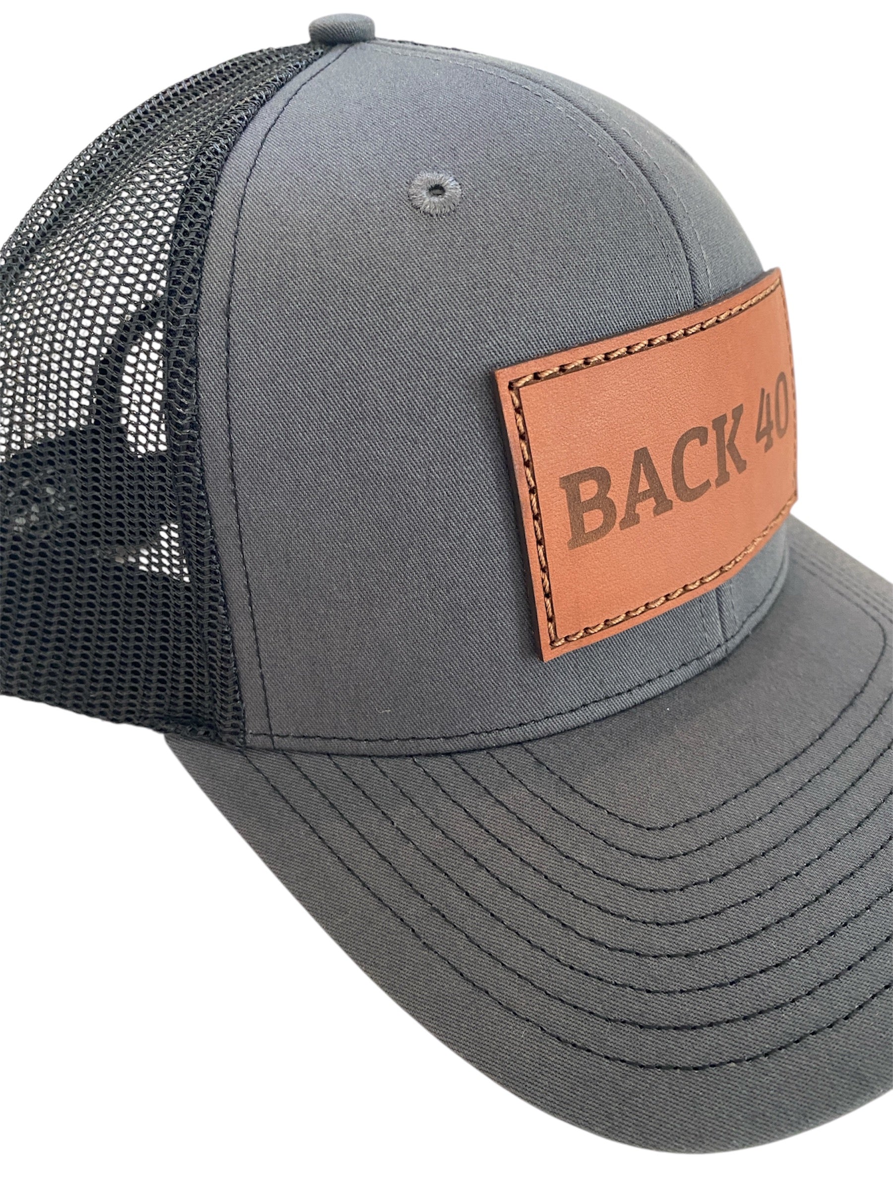 Leather Patch BACK 40 Trucker Hat in charcoal/black