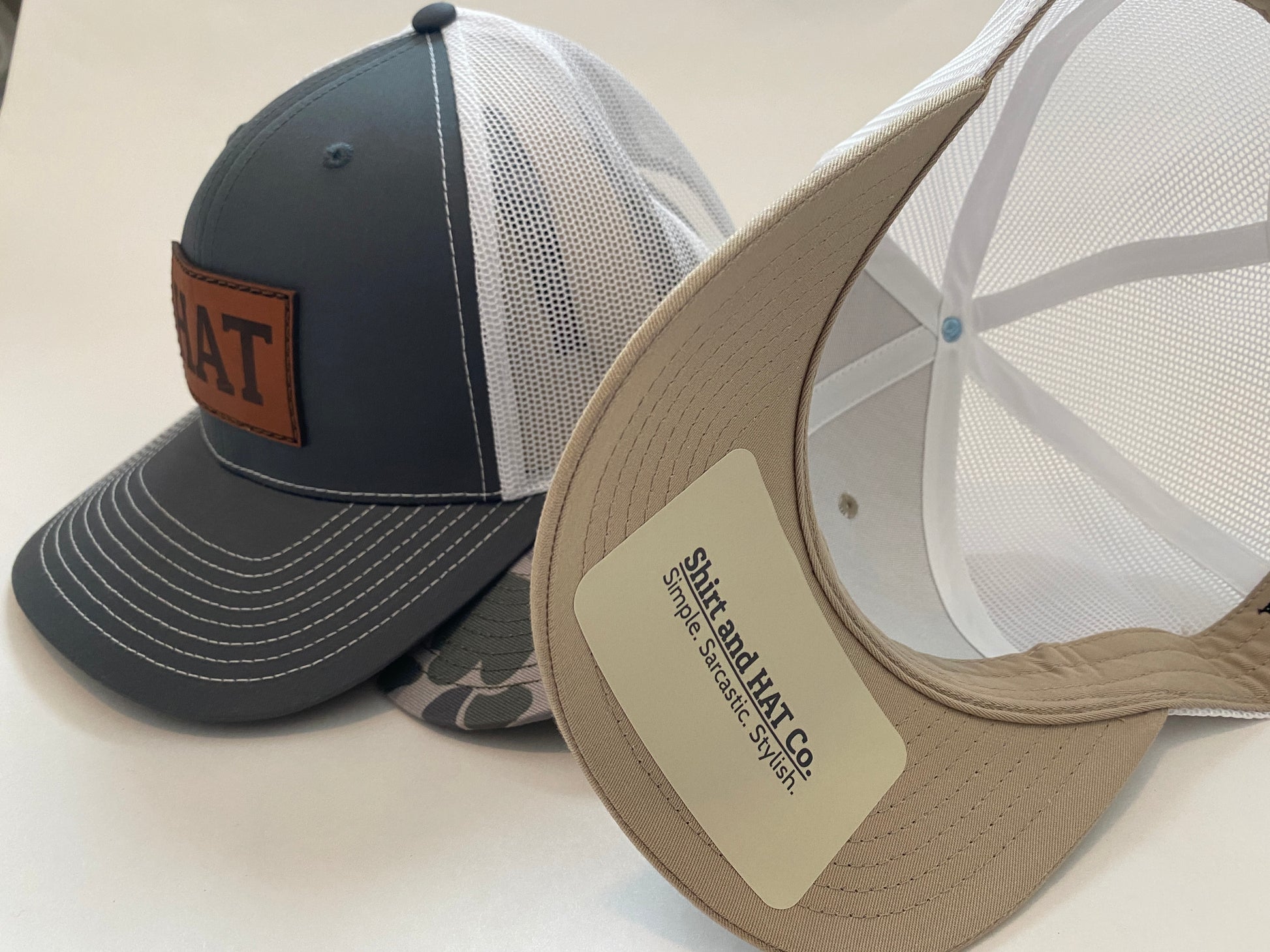 side view of dark gray hat with white mnesh